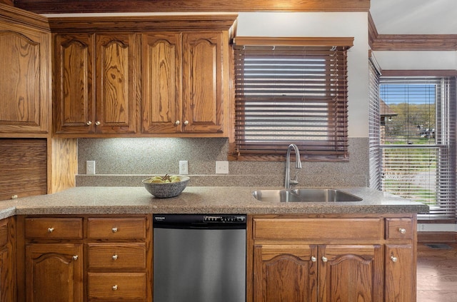 101 Christina Ct, Goodlettsville, TN 37072 - kitchen with stainless steel dishwasher, tasteful backsplash, brown cabinetry, and a sink