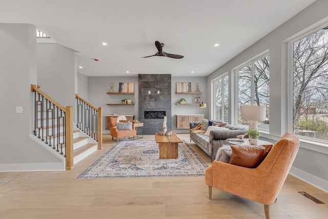 3904 Nevada Ave, Nashville, TN 37209 - living room featuring plenty of natural light, a tile fireplace, light wood-style floors, and baseboards