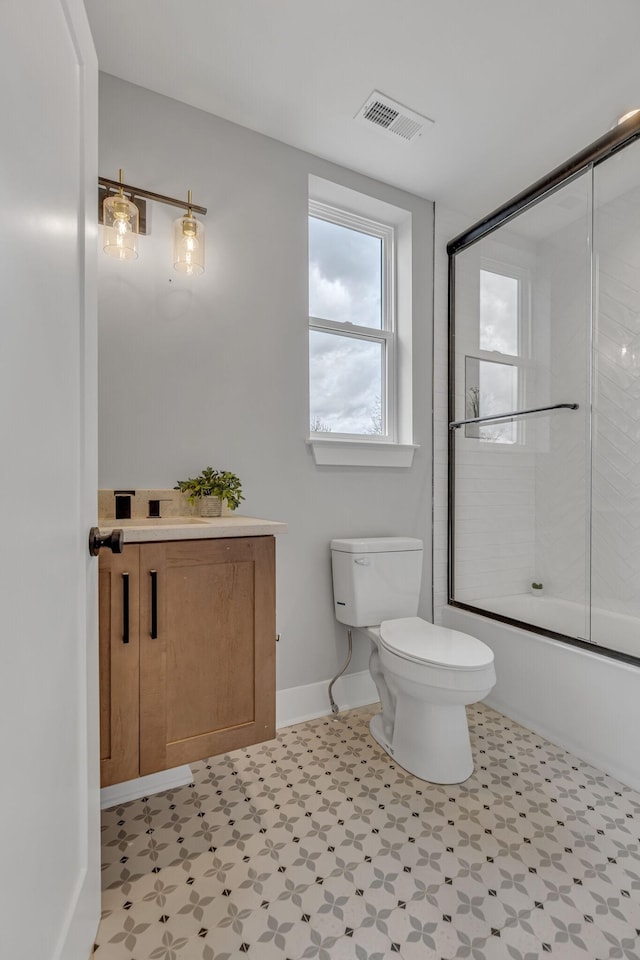 3904 Nevada Ave, Nashville, TN 37209 - full bath with visible vents, toilet, combined bath / shower with glass door, tile patterned floors, and baseboards