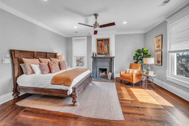 bedroom featuring visible vents, wood finished floors, baseboards, and crown molding