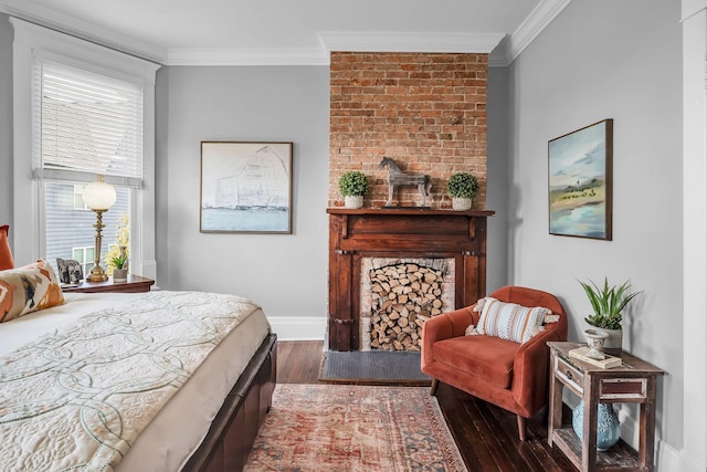 bedroom with baseboards, wood finished floors, a fireplace, and crown molding