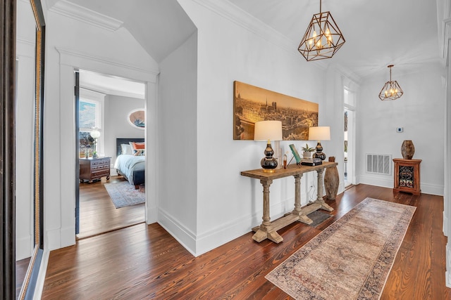 foyer with a chandelier, dark wood finished floors, visible vents, and baseboards