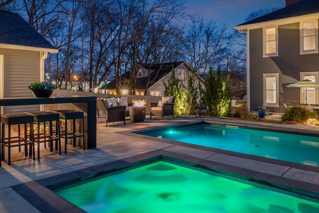 view of swimming pool with fence, a patio, a fenced in pool, and an outdoor fire pit