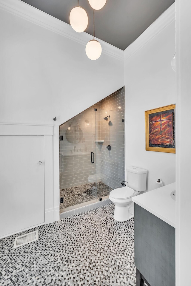 full bathroom featuring tile patterned floors, a stall shower, toilet, vanity, and ornamental molding