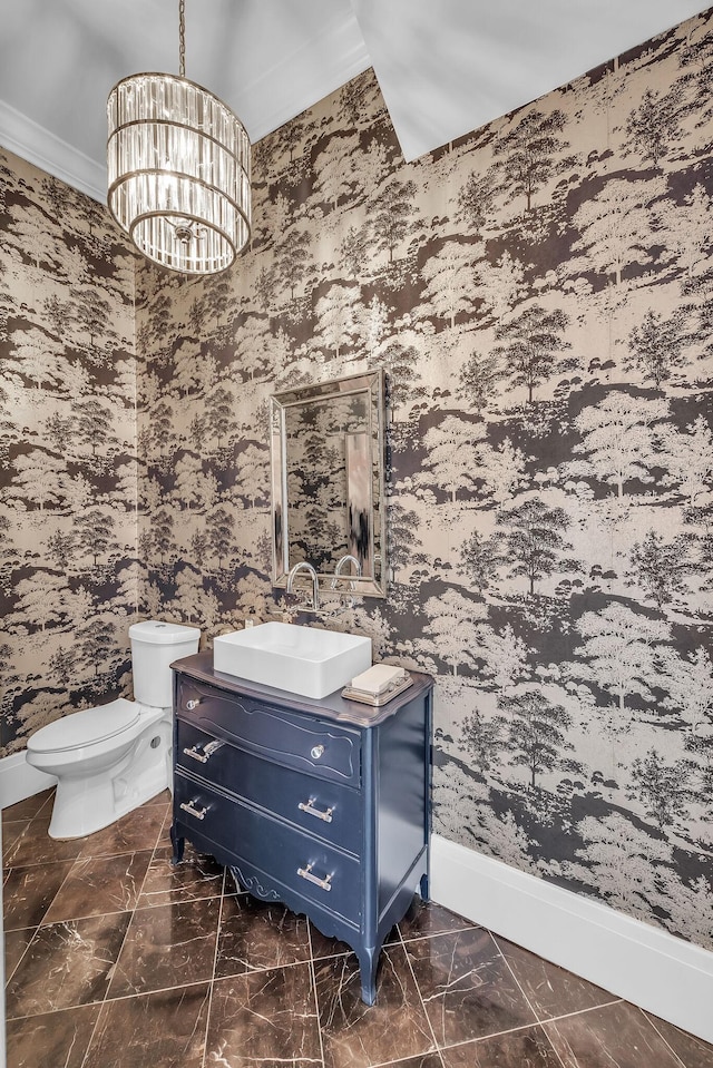 half bath featuring wallpapered walls, baseboards, a chandelier, and vanity