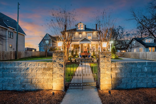 exterior space featuring a porch and a fenced front yard