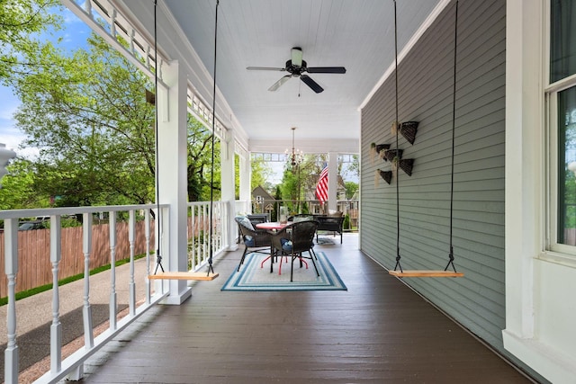wooden deck with outdoor dining area, a porch, and a ceiling fan