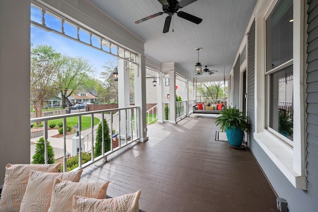 balcony featuring a residential view, a porch, and ceiling fan