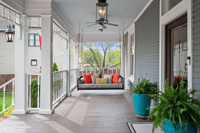 deck with a ceiling fan and a porch