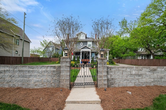 traditional style home with a gate and a fenced front yard