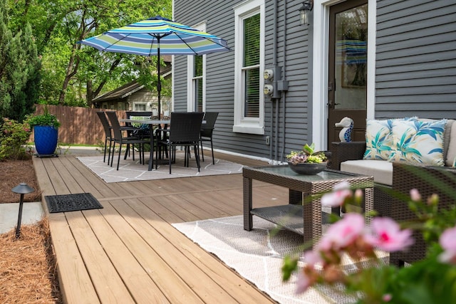 deck featuring fence and outdoor dining space