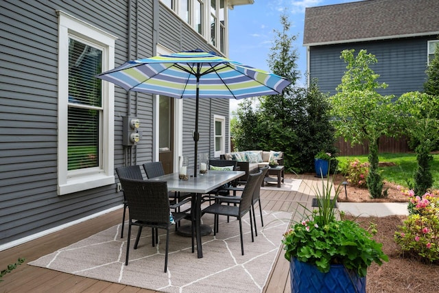 view of patio with outdoor lounge area, outdoor dining area, and a deck