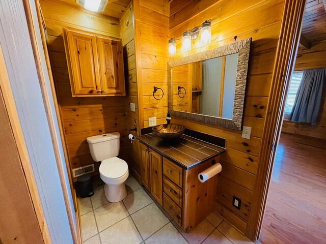 1041 High Meadow Dr, Spencer, TN 38585 - bathroom with vanity, tile patterned floors, wooden walls, toilet, and visible vents