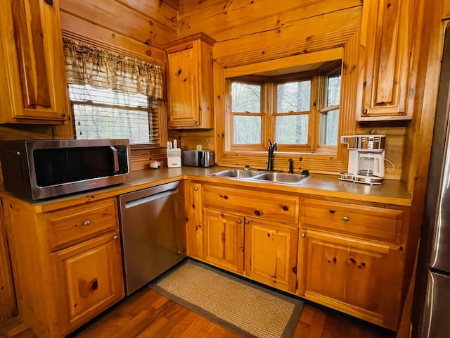 1041 High Meadow Dr, Spencer, TN 38585 - kitchen featuring appliances with stainless steel finishes, a sink, brown cabinets, wooden walls, and dark wood-style floors