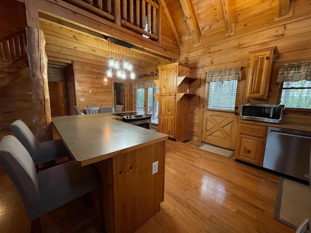 1041 High Meadow Dr, Spencer, TN 38585 - kitchen featuring stainless steel appliances, wooden walls, high vaulted ceiling, and light wood finished floors