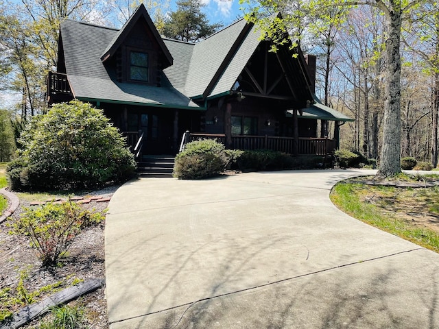 1041 High Meadow Dr, Spencer, TN 38585 - view of front of property with a porch, a chimney, a shingled roof, and driveway