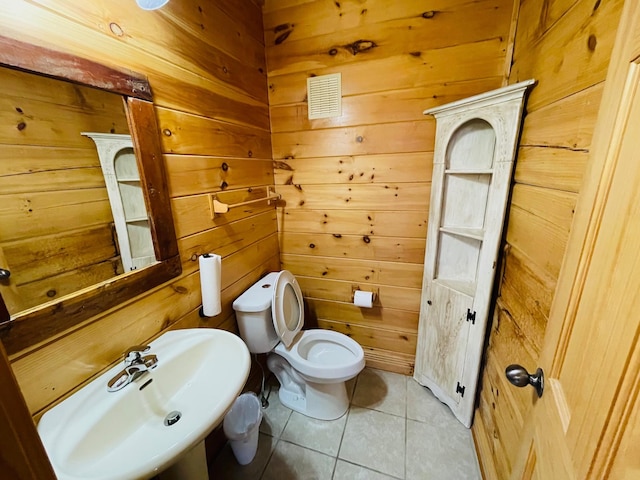 1041 High Meadow Dr, Spencer, TN 38585 - bathroom featuring visible vents, a sink, toilet, wood walls, and tile patterned flooring