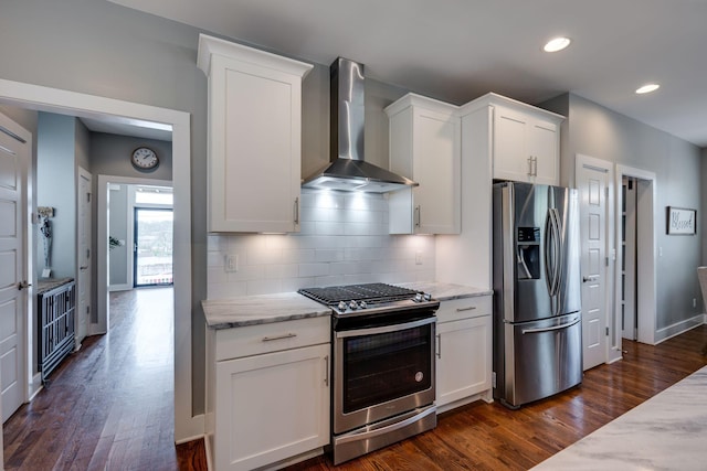 72 Twin St, Nashville, TN 37209 - kitchen with backsplash, light stone countertops, dark wood-type flooring, wall chimney exhaust hood, and appliances with stainless steel finishes