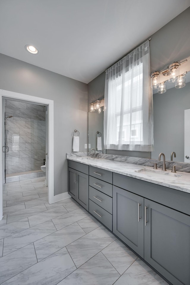 72 Twin St, Nashville, TN 37209 - full bathroom with double vanity, toilet, a shower stall, marble finish floor, and a sink