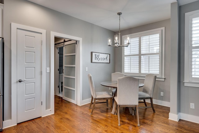 72 Twin St, Nashville, TN 37209 - dining space with a barn door, baseboards, a notable chandelier, and wood finished floors