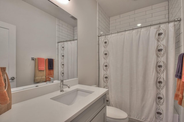 full bathroom with toilet, vanity, and curtained shower