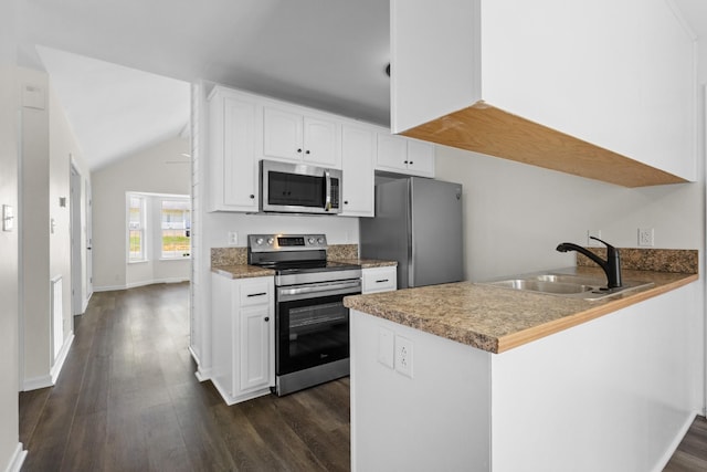 438 Pacific Ave, Oak Grove, KY 42262 - kitchen featuring dark wood finished floors, a peninsula, white cabinets, appliances with stainless steel finishes, and a sink