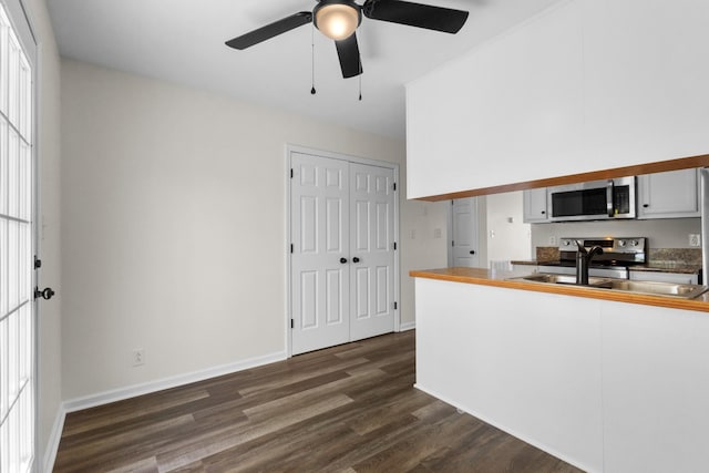 438 Pacific Ave, Oak Grove, KY 42262 - kitchen featuring ceiling fan, dark wood-type flooring, a sink, stainless steel appliances, and baseboards
