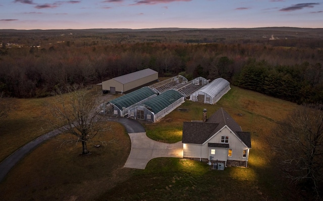 drone / aerial view with a wooded view