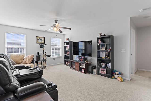 carpeted living room with baseboards and ceiling fan
