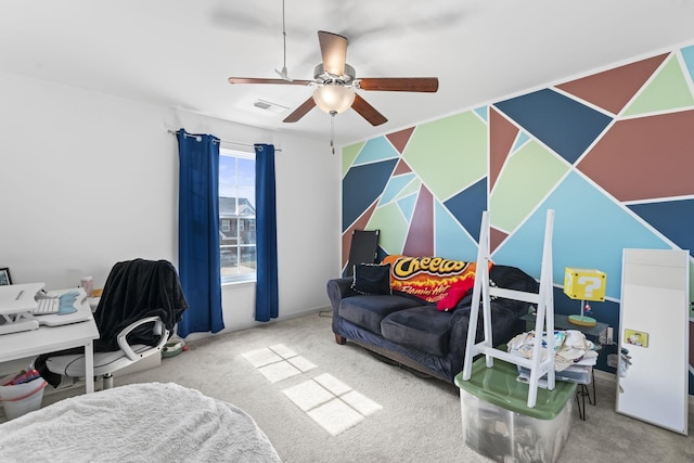 carpeted home office with ceiling fan and visible vents