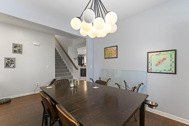 dining space with an inviting chandelier, baseboards, dark wood-style floors, and stairs