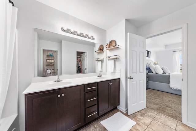 ensuite bathroom featuring double vanity, a sink, tile patterned flooring, and ensuite bath