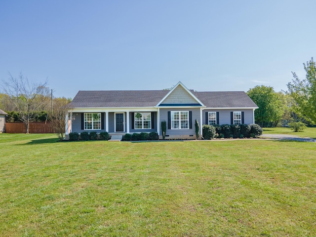 ranch-style home with a front yard and fence