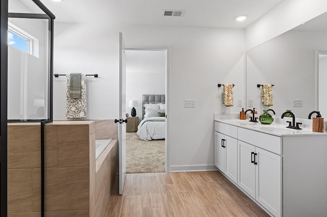 8524 Turnbull Dr, Pleasant View, TN 37146 - full bathroom featuring double vanity, wood finished floors, a bath, connected bathroom, and recessed lighting