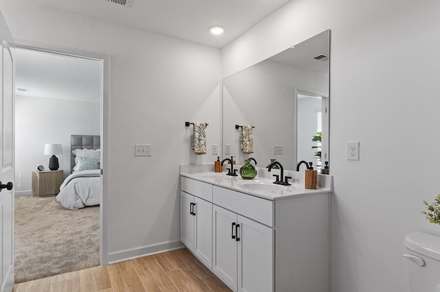 8524 Turnbull Dr, Pleasant View, TN 37146 - ensuite bathroom with double vanity, wood finished floors, and baseboards