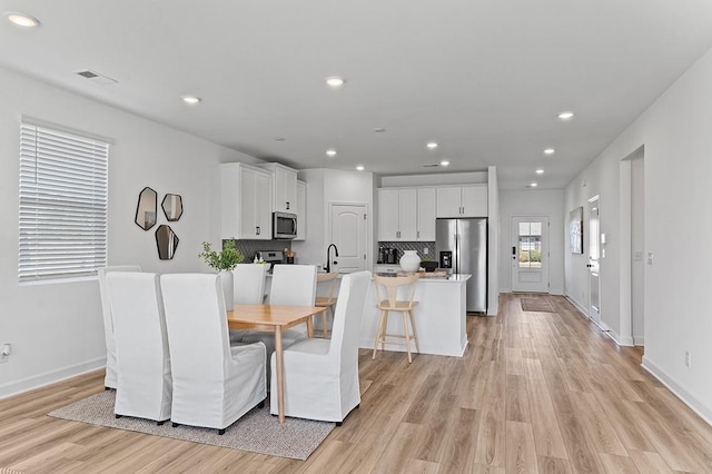 8524 Turnbull Dr, Pleasant View, TN 37146 - dining room with light wood-type flooring, baseboards, and recessed lighting