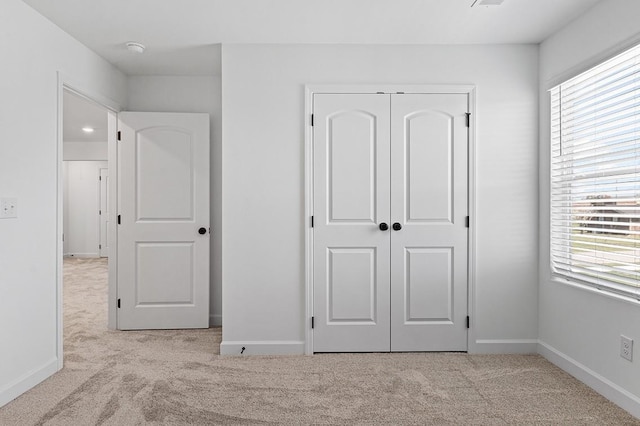 8524 Turnbull Dr, Pleasant View, TN 37146 - unfurnished bedroom with carpet flooring, multiple windows, a closet, and baseboards