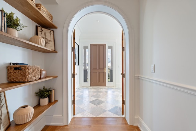 2109 10th Ave S, Nashville, TN 37204 - hallway with light wood-style flooring, arched walkways, and baseboards
