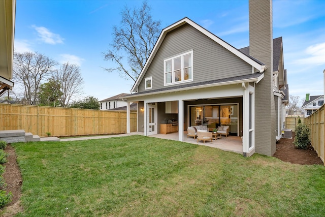 2109 10th Ave S, Nashville, TN 37204 - rear view of house with an outdoor hangout area, a yard, a fenced backyard, a patio area, and a chimney