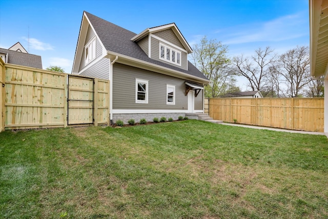 2109 10th Ave S, Nashville, TN 37204 - back of property with a yard, roof with shingles, entry steps, and fence