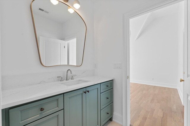 2109 10th Ave S, Nashville, TN 37204 - bathroom featuring visible vents, baseboards, vanity, and wood finished floors