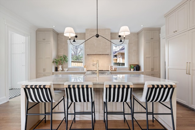 2109 10th Ave S, Nashville, TN 37204 - kitchen with a kitchen bar, recessed lighting, a spacious island, wood finished floors, and light stone counters