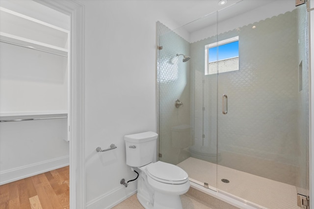 2109 10th Ave S, Nashville, TN 37204 - bathroom featuring toilet, a stall shower, wood finished floors, and baseboards
