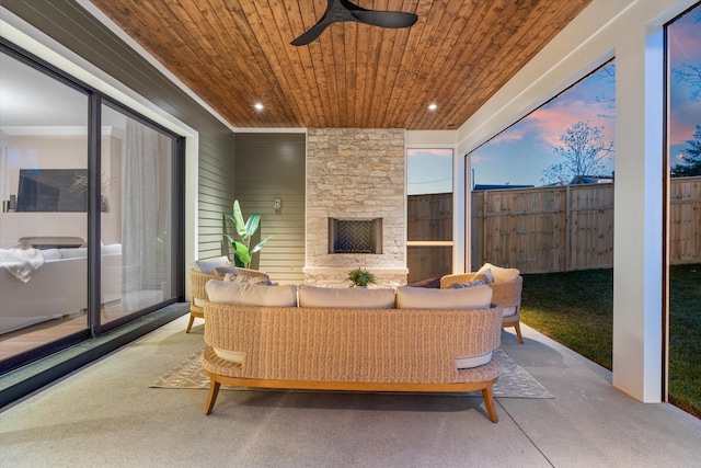 2109 10th Ave S, Nashville, TN 37204 - patio terrace at dusk featuring fence, ceiling fan, and an outdoor living space with a fireplace