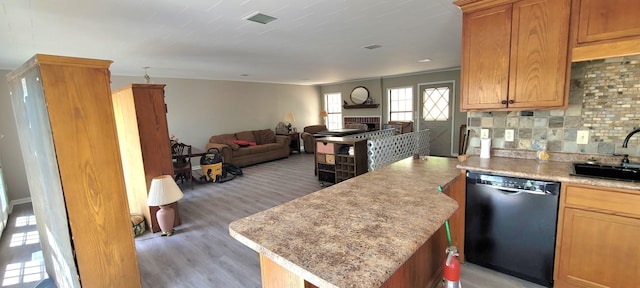 1124 Woodlawn Shores Rd, Sugar Tree, TN 38380 - kitchen with light wood-style flooring, visible vents, black dishwasher, open floor plan, and decorative backsplash