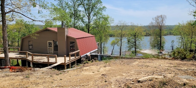 1124 Woodlawn Shores Rd, Sugar Tree, TN 38380 - exterior space featuring a gambrel roof, a deck with water view, and a chimney