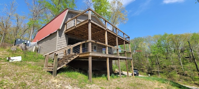 1124 Woodlawn Shores Rd, Sugar Tree, TN 38380 - rear view of house featuring a forest view, a wooden deck, metal roof, and stairway