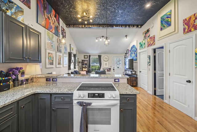 1204A Keller Ave, Nashville, TN 37216 - kitchen featuring light wood finished floors, electric range, a peninsula, and lofted ceiling