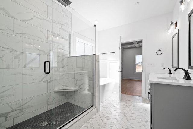 bathroom featuring a soaking tub, visible vents, a sink, a stall shower, and double vanity