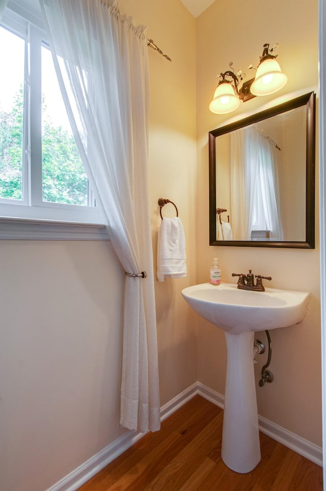 bathroom featuring wood finished floors and baseboards
